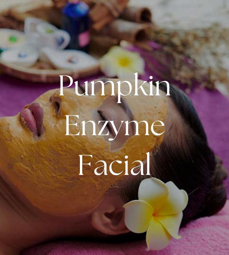 Close-up of a Pumpkin Enzyme Facial treatment mask being applied to a woman's face.